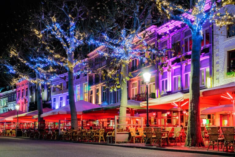 Bars and restaurants with christmas lights on the famous Vrijthof square in Maastricht